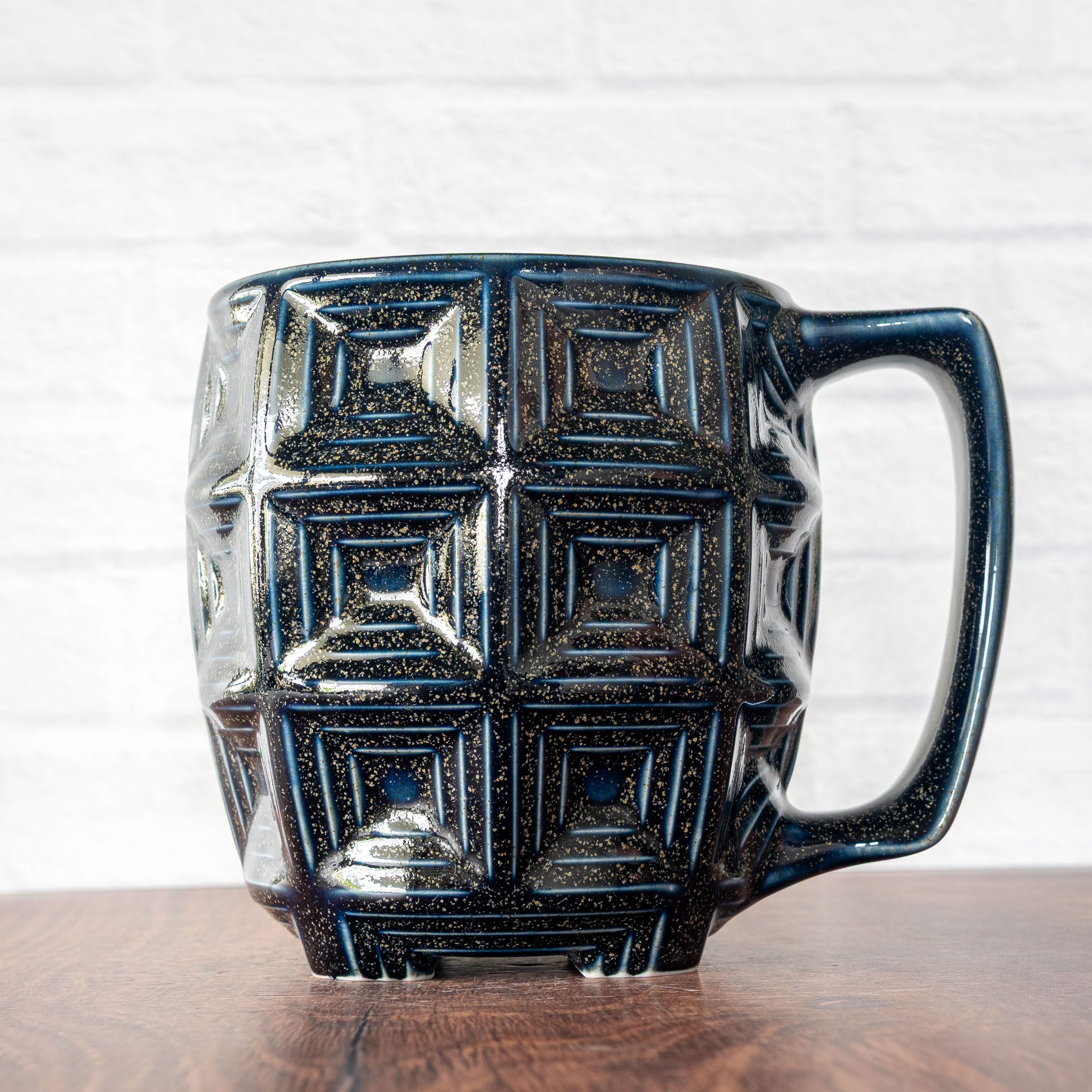 Hammerly Ceramics handmade slip-cast mug in glossy deep navy glaze with gold speckles, barrel-shaped with concentric recessed squares