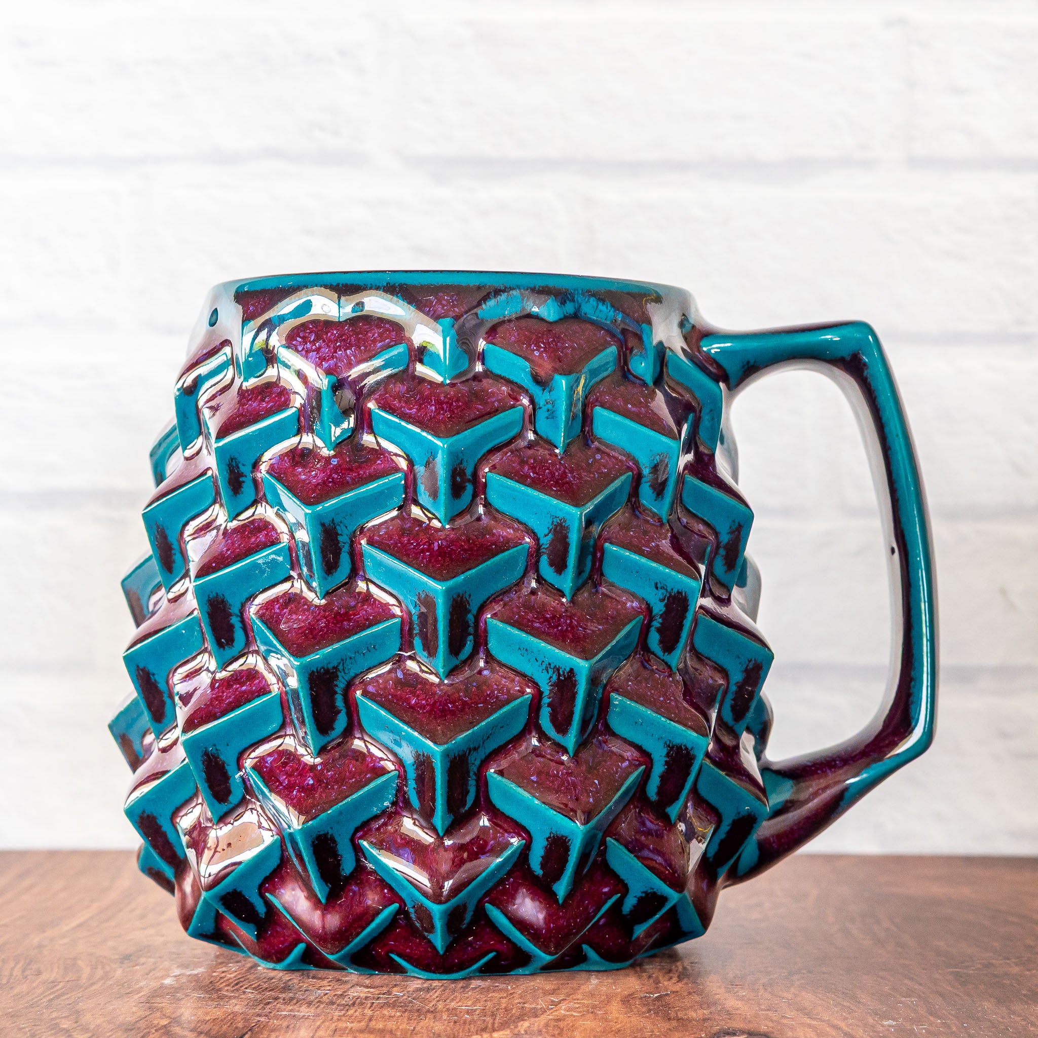 Hammerly Ceramics handmade slip-cast mug in glossy deep crimson and teal, geometric cubes textured porcelain
