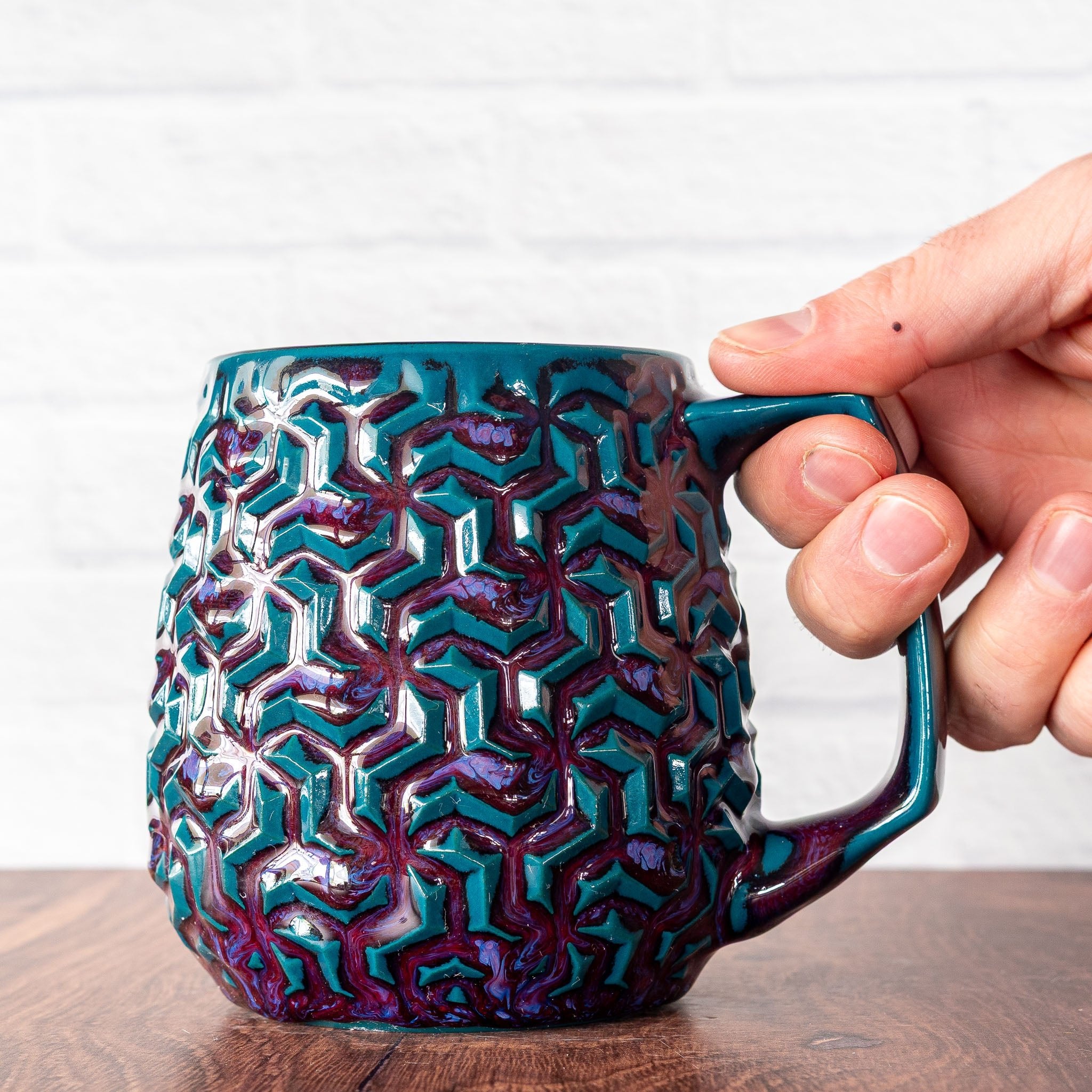 Hammerly Ceramics handmade decorative statue in glossy deep crimson and teal, interlocking geometric weave textured porcelain