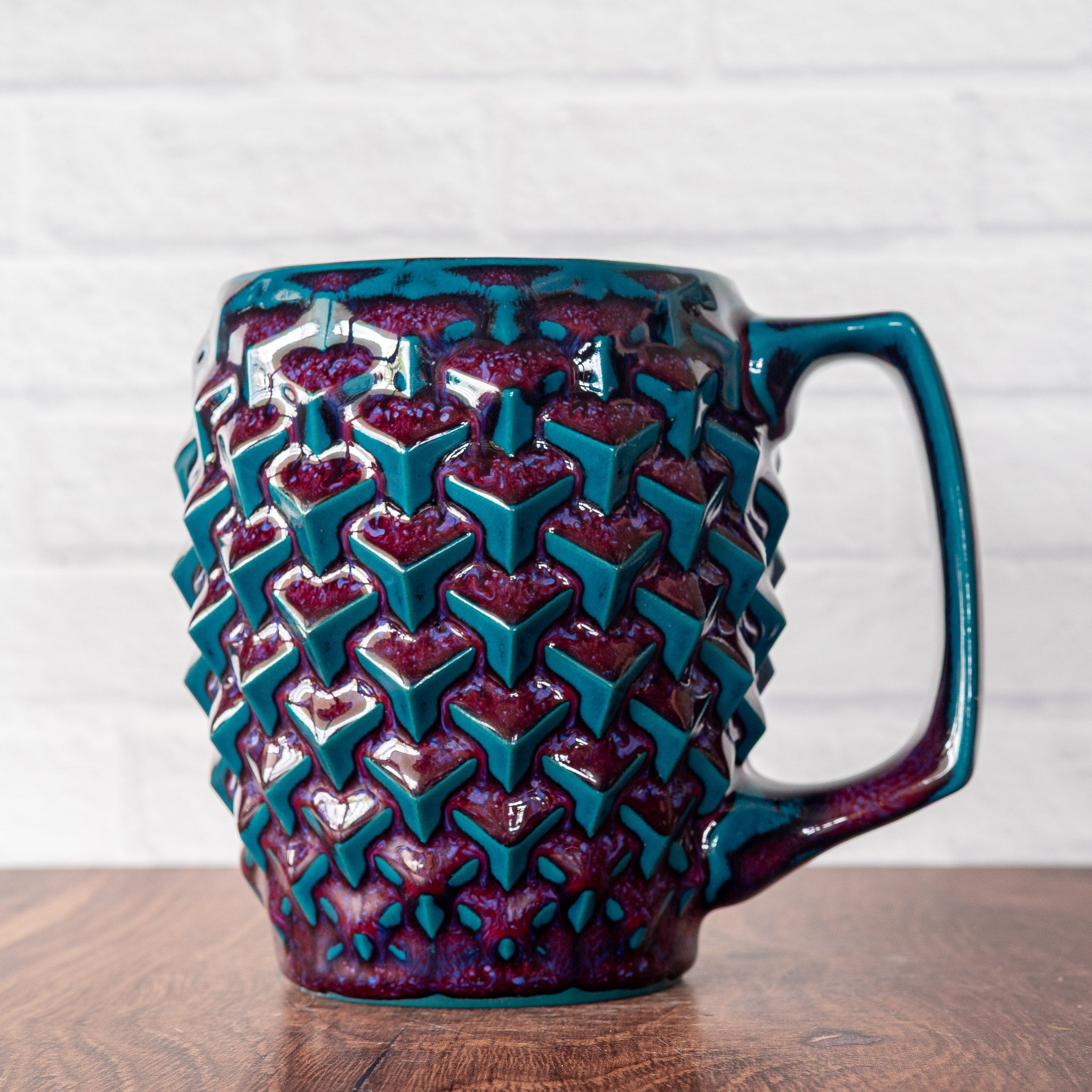 Hammerly Ceramics handmade slip-cast mug in glossy deep crimson and teal, geometric cubes textured porcelain