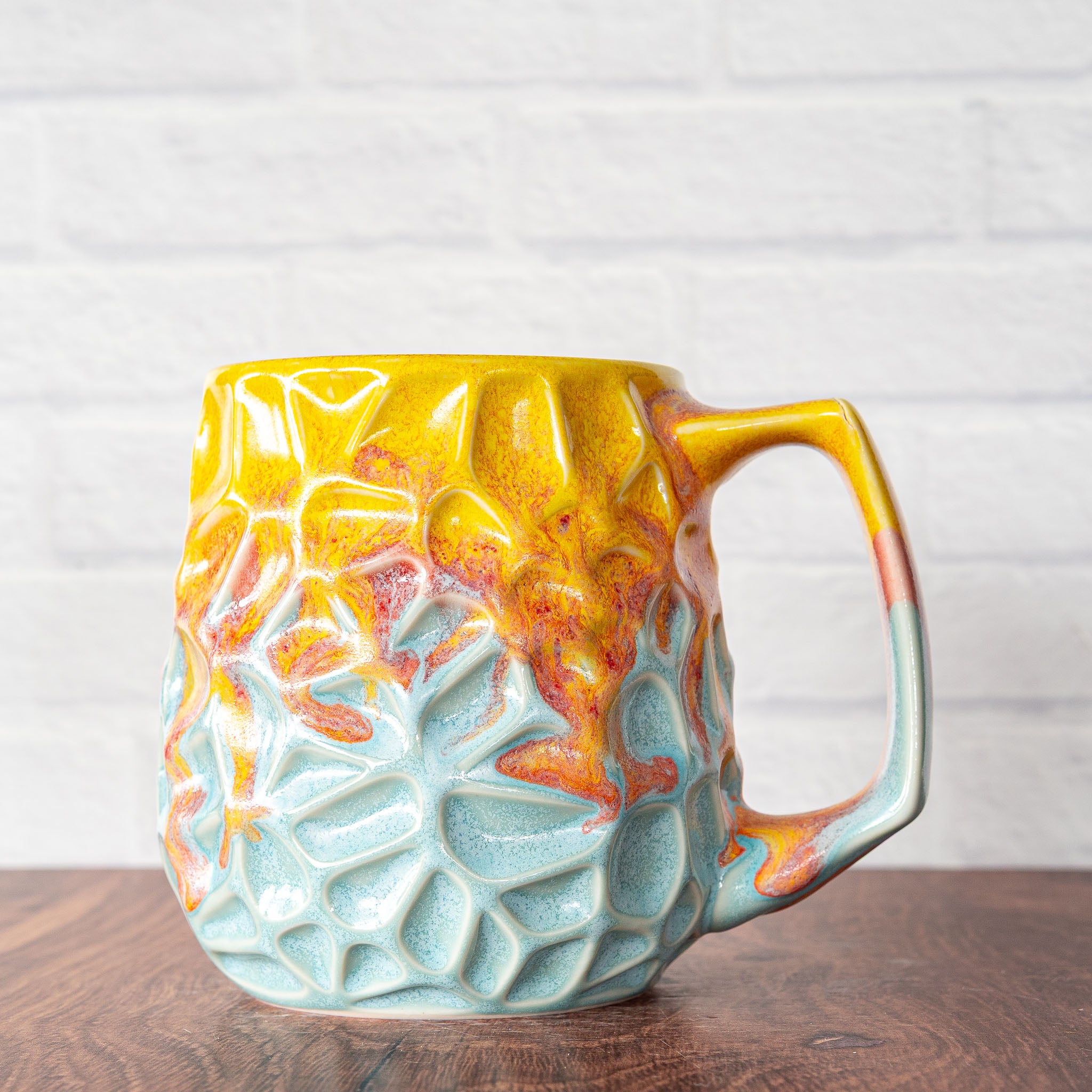 Hammerly Ceramics handmade slip-cast mug in yellow and sky blue with flowing orange blush, geometric organic cell-like textured porcelain