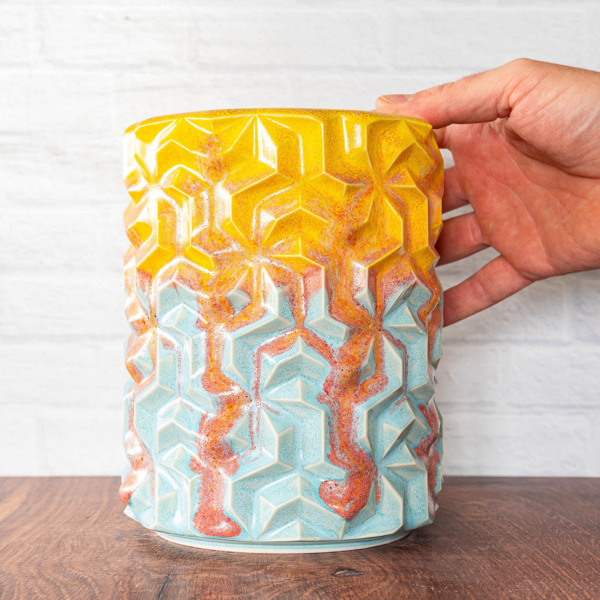 Hammerly Ceramics handmade slip-cast vase in yellow and sky blue with flowing orange blush , interlocking geometric weave textured porcelain