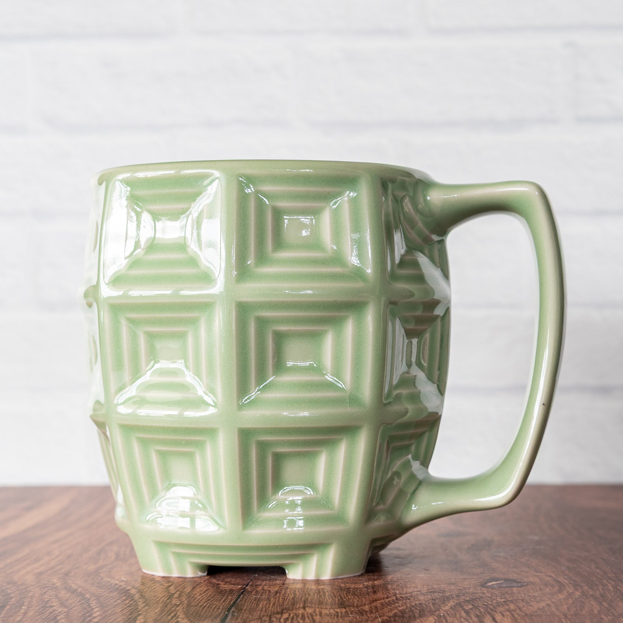 Hammerly Ceramics handmade slip-cast mug in glossy, translucent green celadon glaze, barrel-shaped with concentric recessed squares