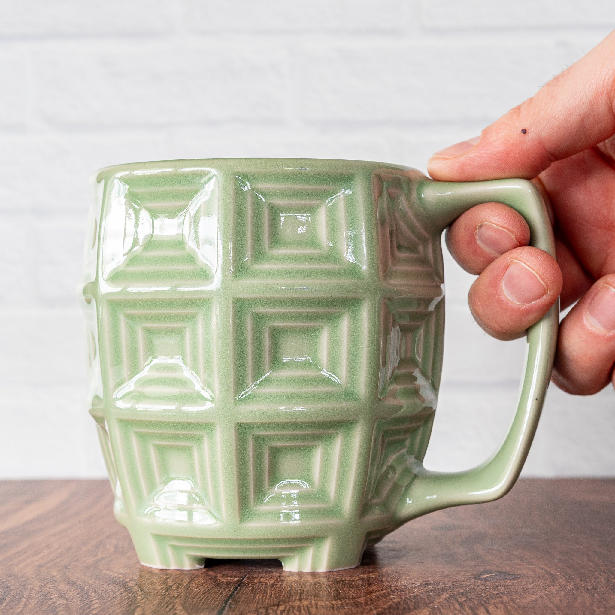 Hammerly Ceramics handmade slip-cast mug in glossy, translucent green celadon glaze, barrel-shaped with concentric recessed squares