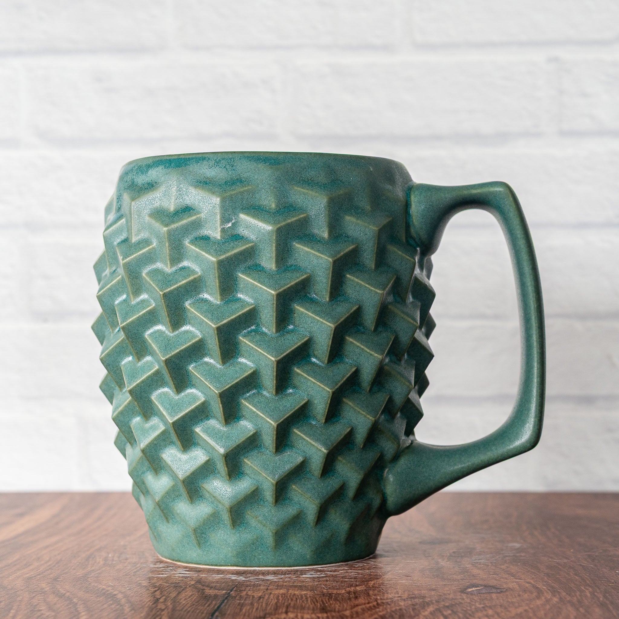 Hammerly Ceramics handmade slip-cast mug in smooth, matte jade green, geometric cubes textured porcelain