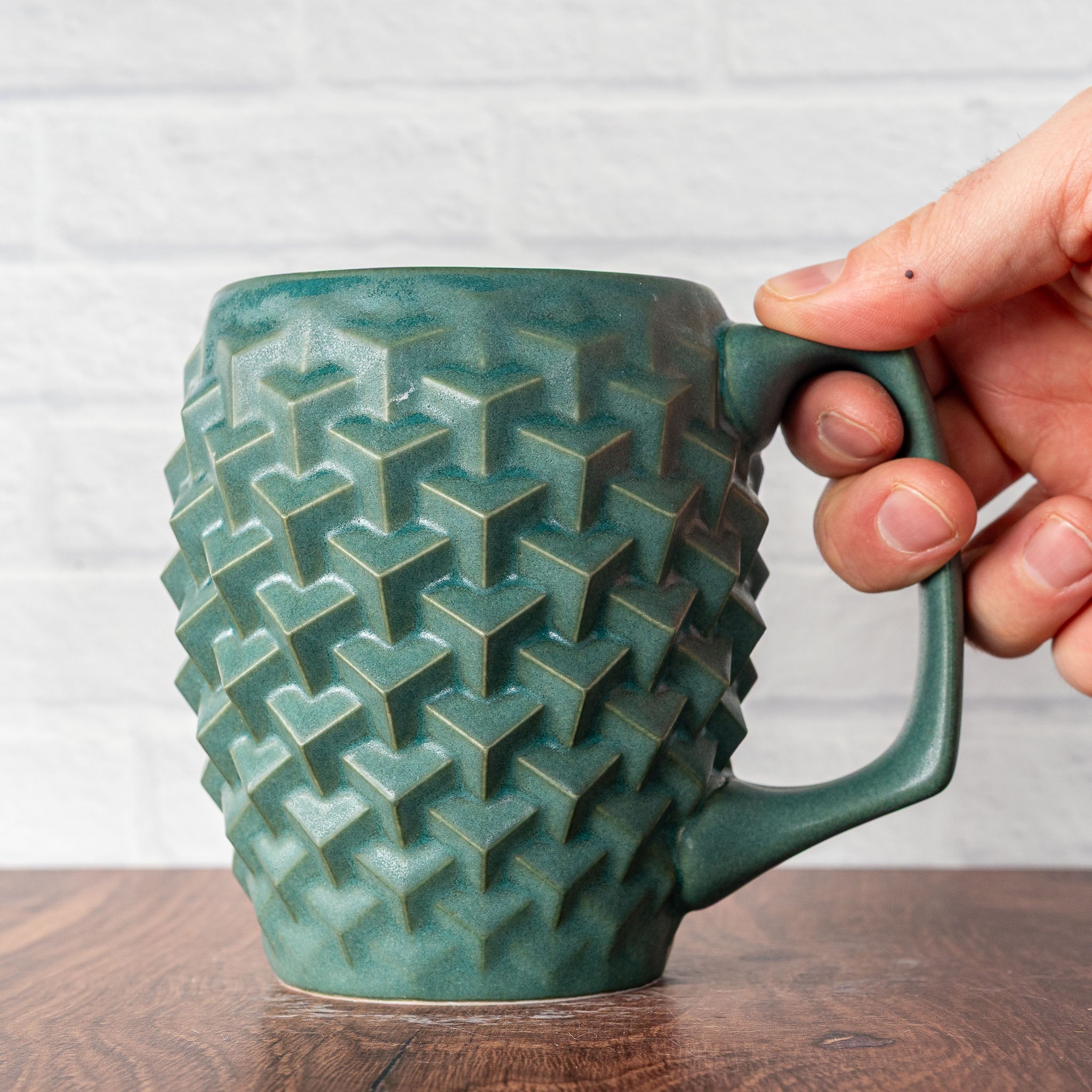 Hammerly Ceramics handmade slip-cast mug in smooth, matte jade green, geometric cubes textured porcelain