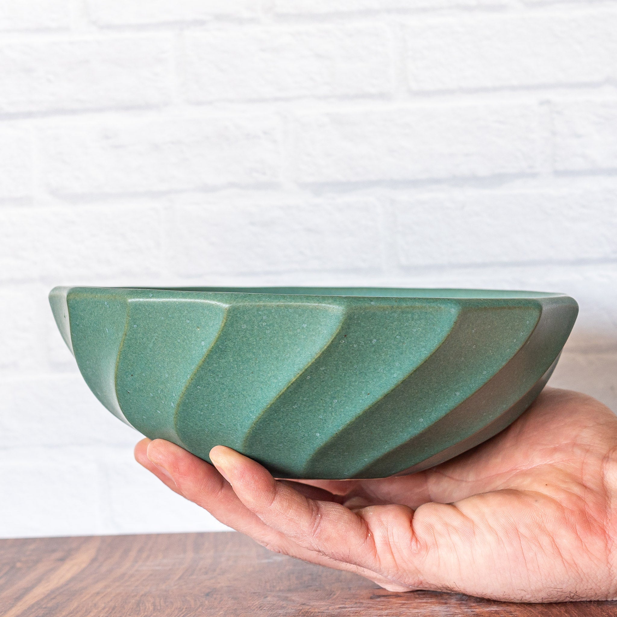 Hammerly Ceramics handmade slip-cast bowl in smooth, matte jade green, geometric twist texture
