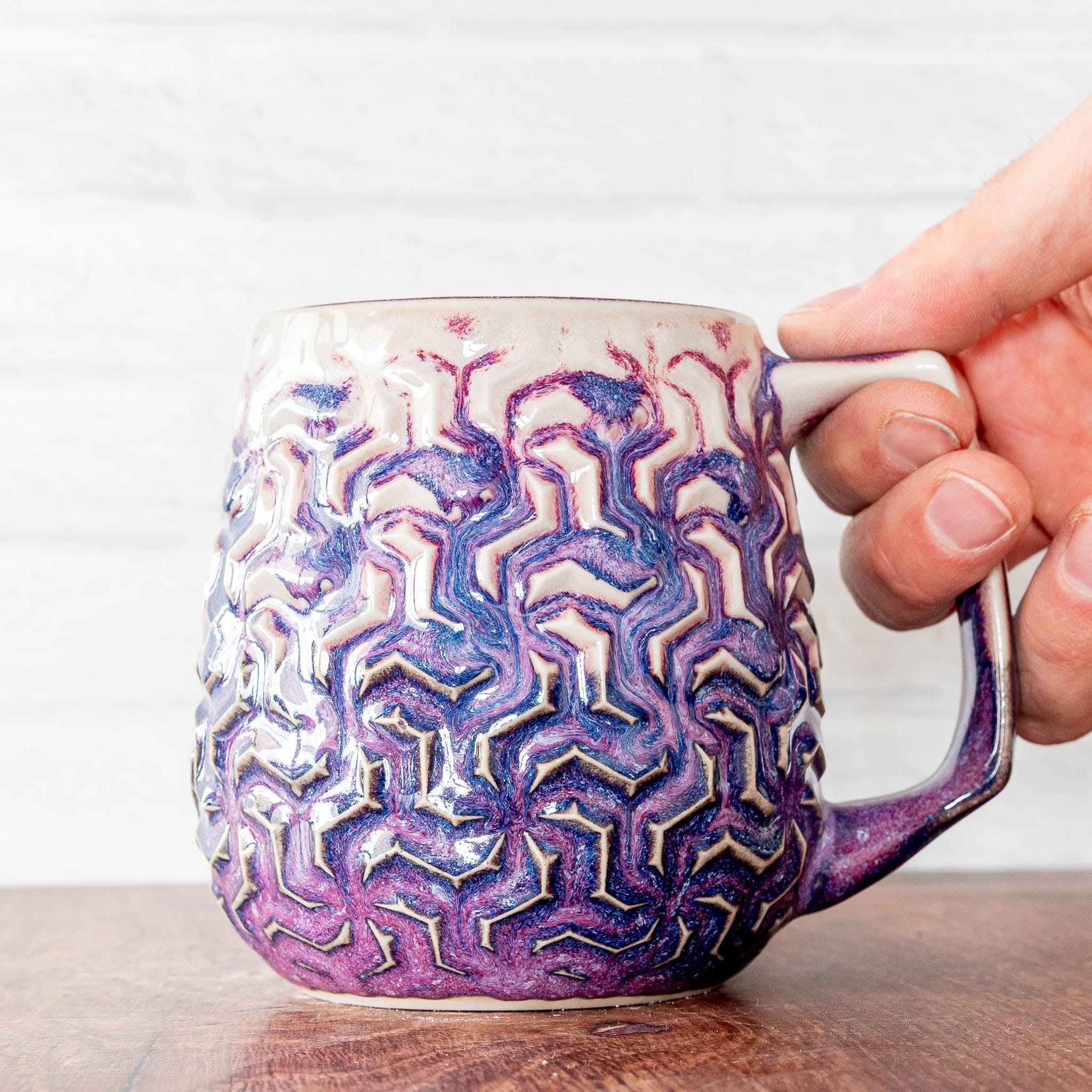 Hammerly Ceramics handmade decorative statue in white and deep navy glaze with purple drip transition, interlocking geometric weave textured porcelain