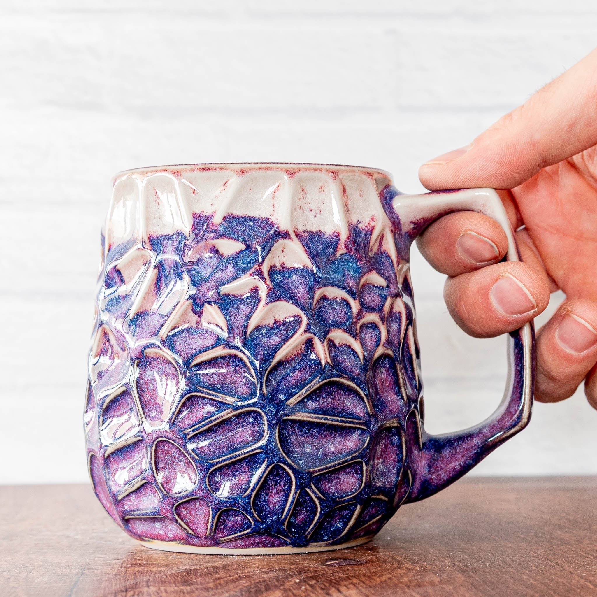 Hammerly Ceramics handmade slip-cast mug in white and deep navy glaze with purple drip transition, geometric organic cell-like textured porcelain