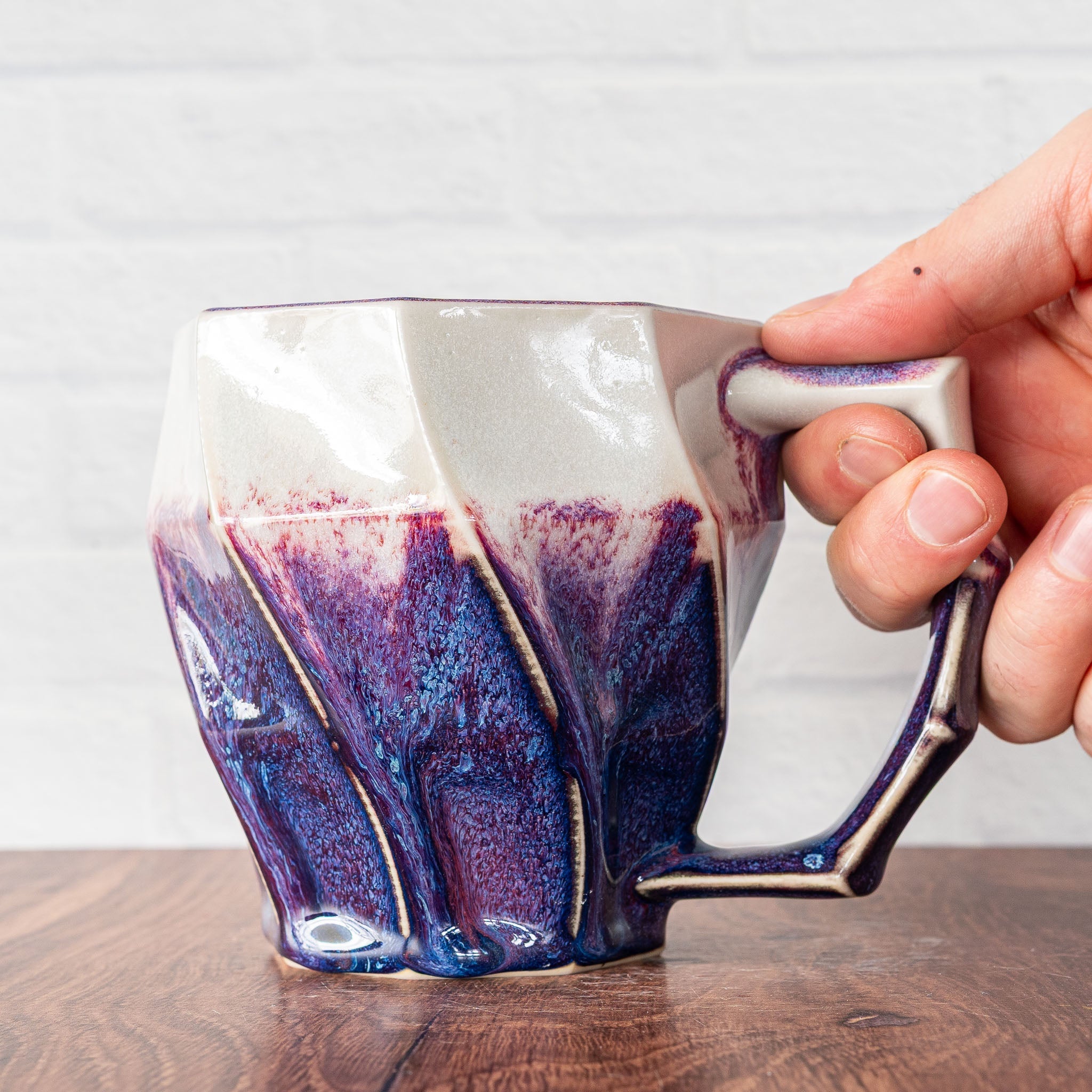 Hammerly Ceramics handmade slip-cast Classic Mug inwhite and deep navy glaze with purple drip transition, faceted porcelain with angular handle