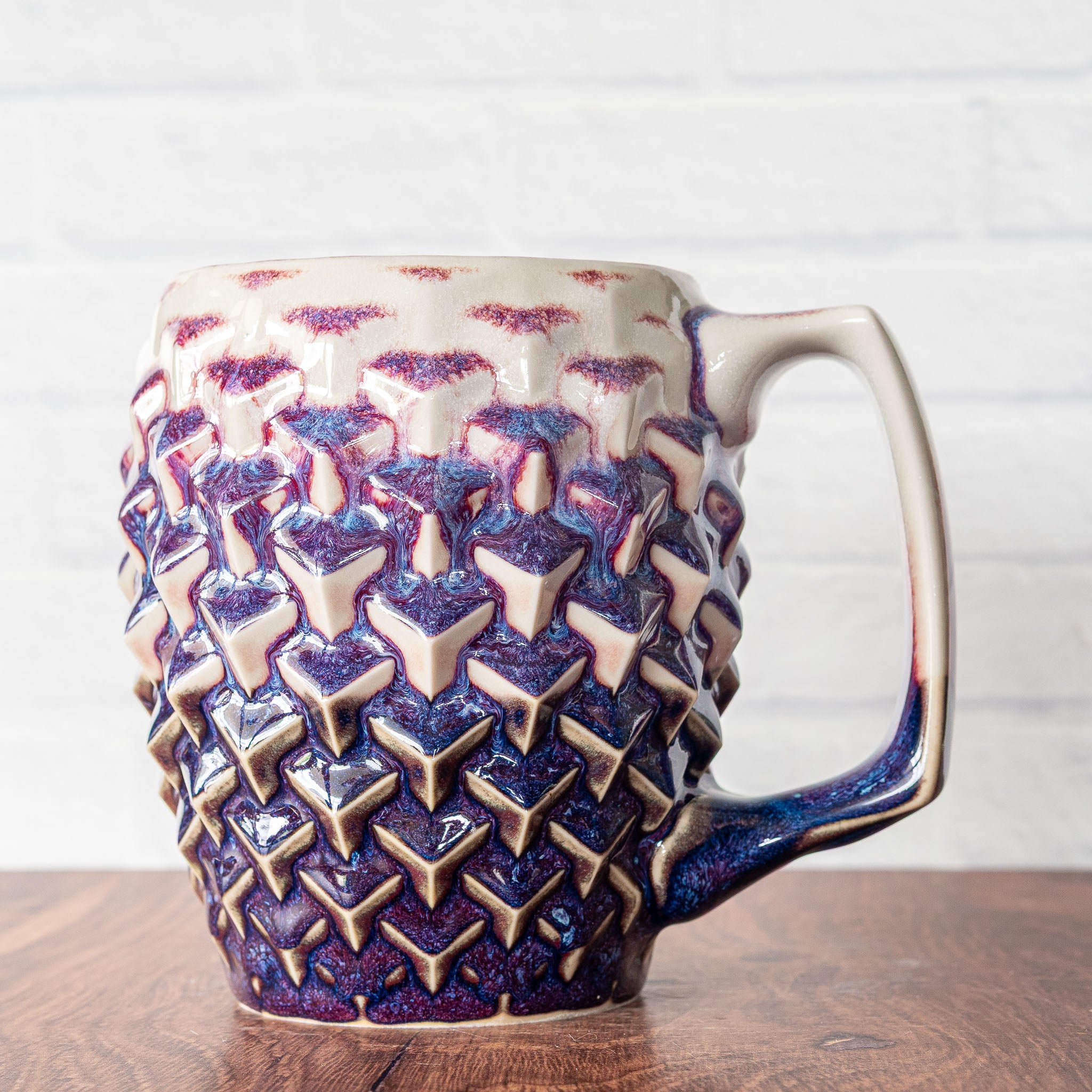 Hammerly Ceramics handmade slip-cast mug in white and deep navy glaze with purple drip transition, geometric cubes textured porcelain