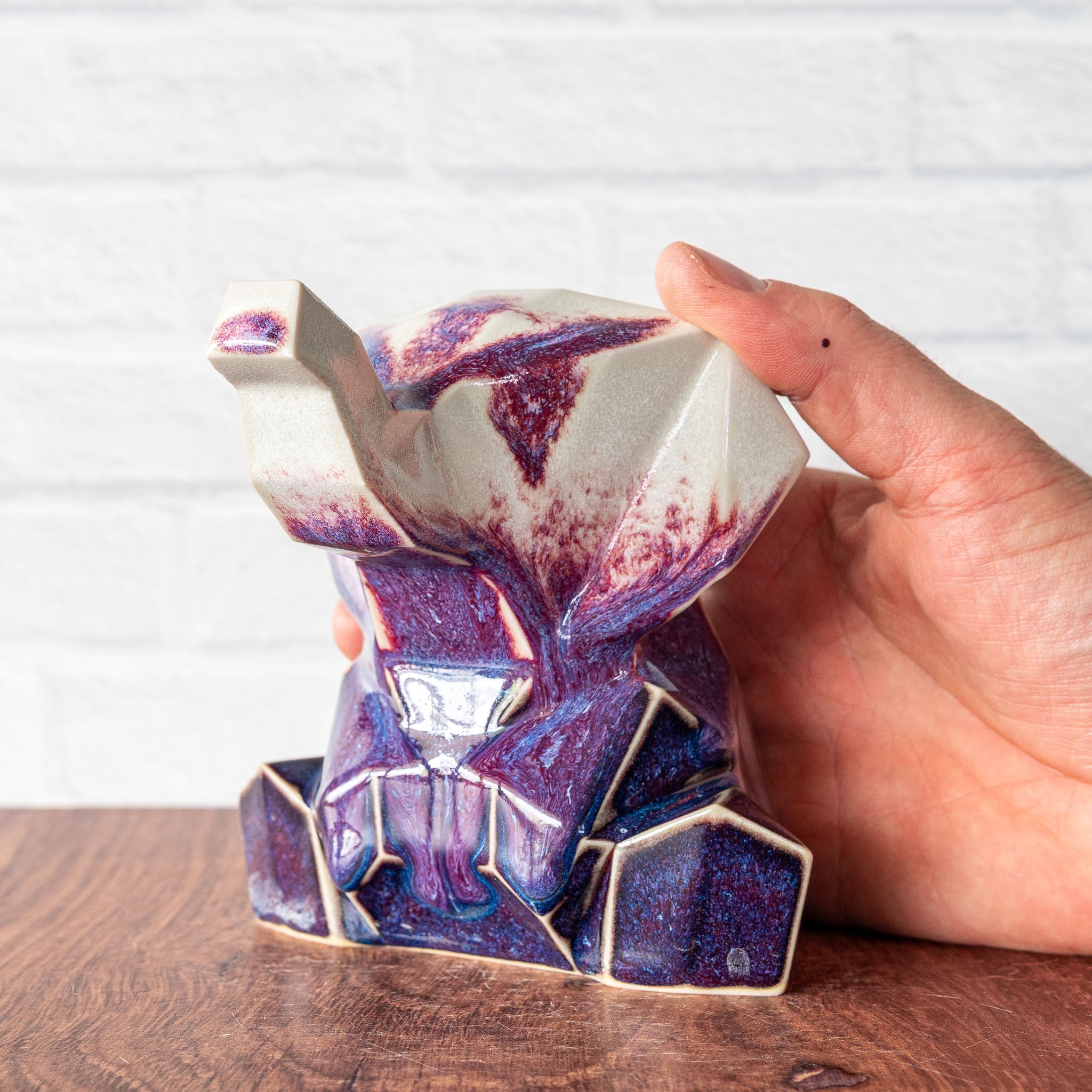 Hammerly Ceramics handmade decorative elephant statue in white and deep navy glaze with purple drip transition, geometric elephant form