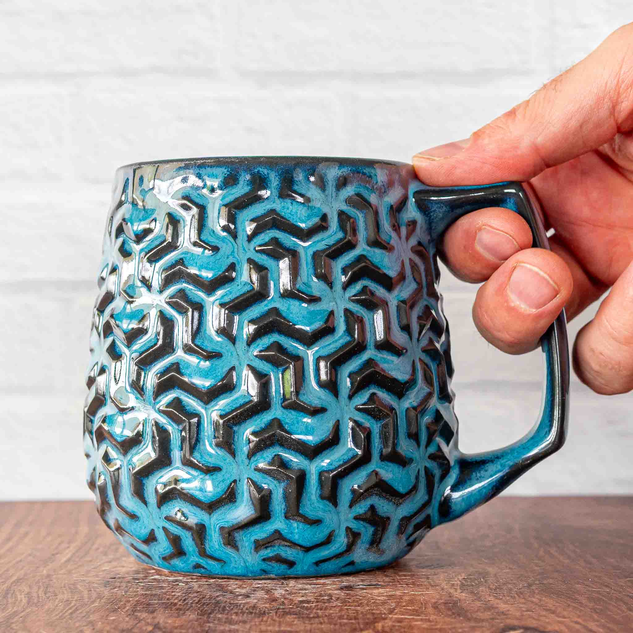 Hammerly Ceramics handmade decorative statue in ocean blue glaze with dark charcoal edges, interlocking geometric weave textured porcelain