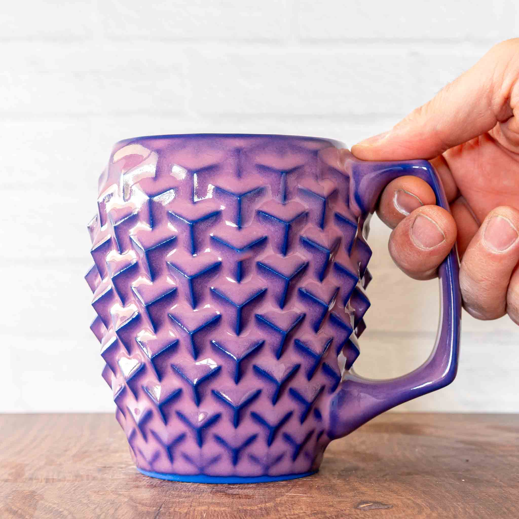 Hammerly Ceramics handmade slip-cast mug in violet over dark blue purple edges, geometric cubes textured porcelain