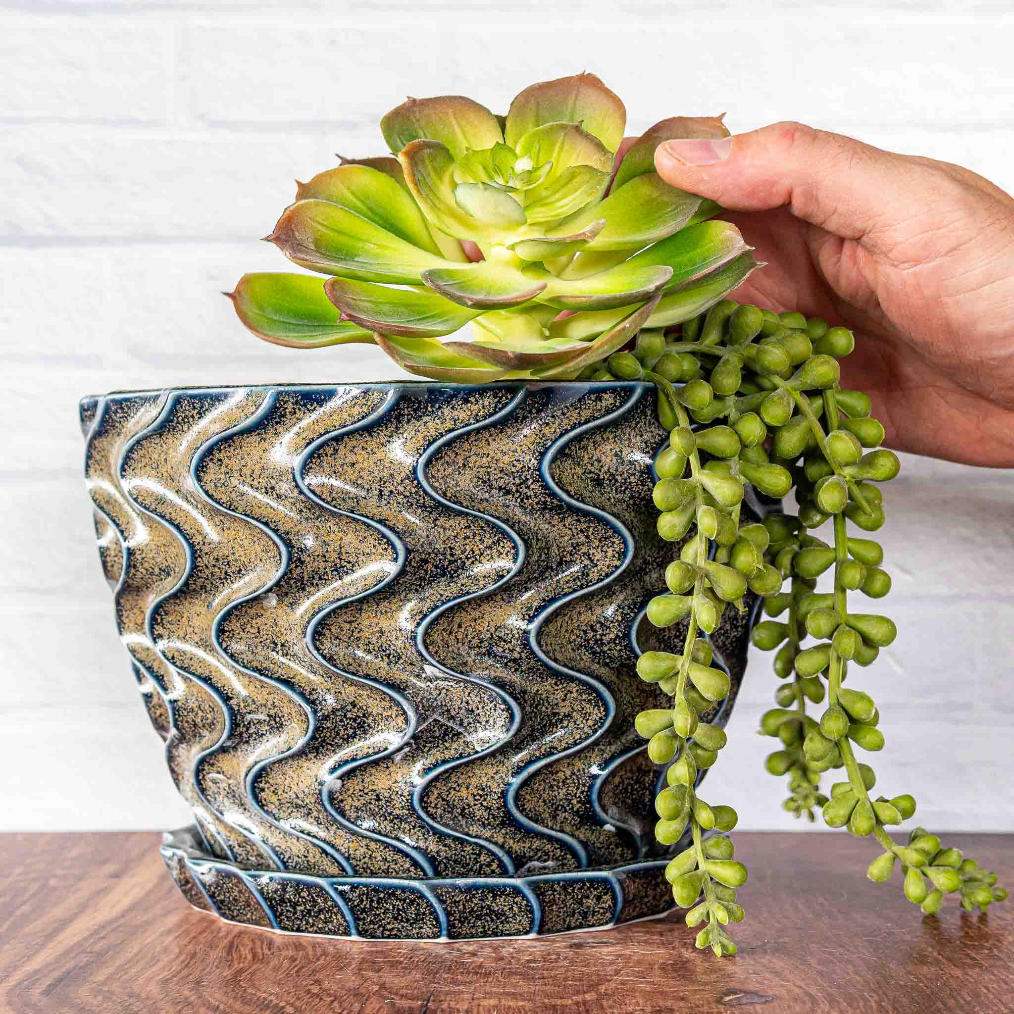 Hammerly Ceramics handmade slip-cast planter in glossy deep navy glaze with gold speckles, deep wavy textured porcelain with drip tray