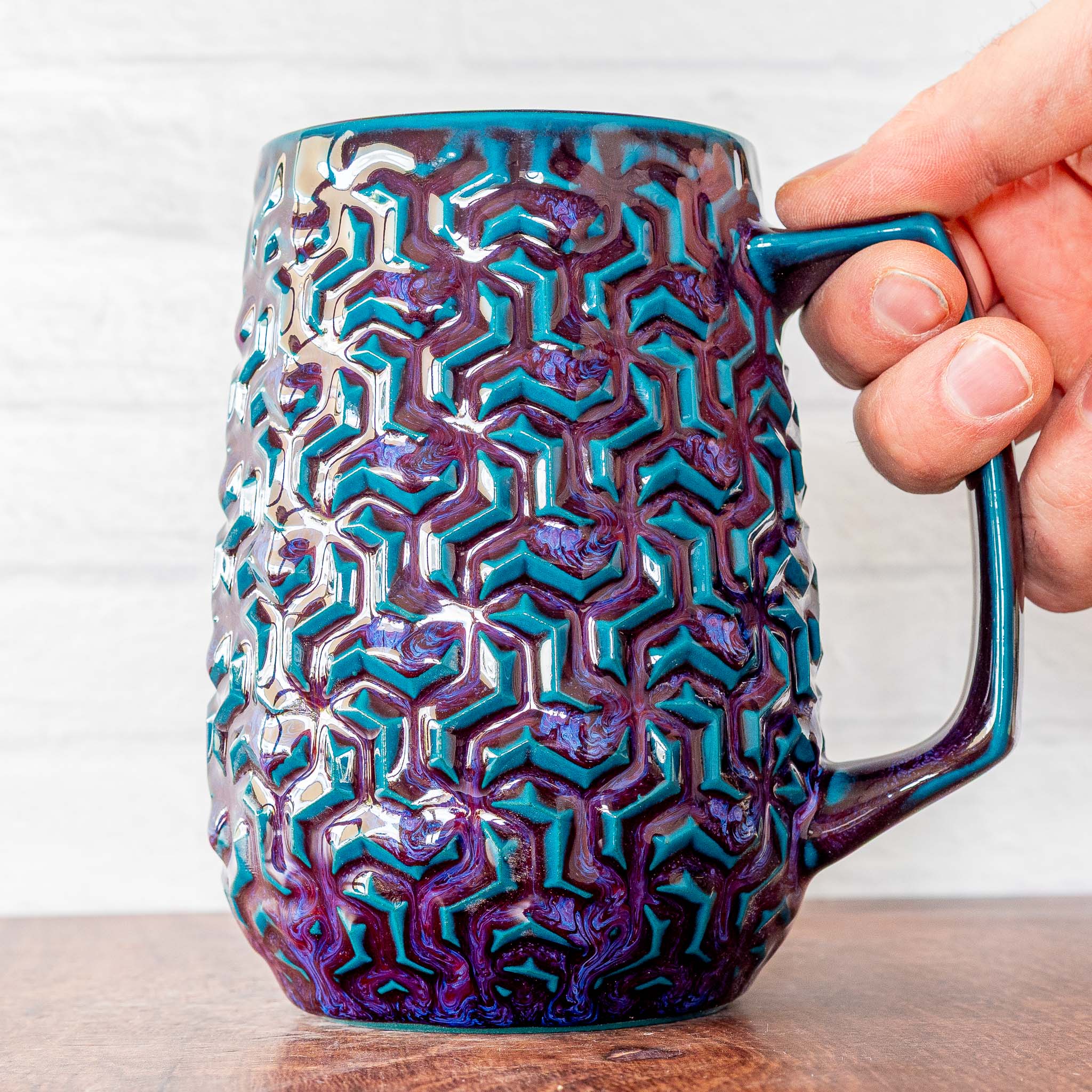 Hammerly Ceramics handmade decorative statue in glossy deep crimson and teal , interlocking geometric weave textured porcelain