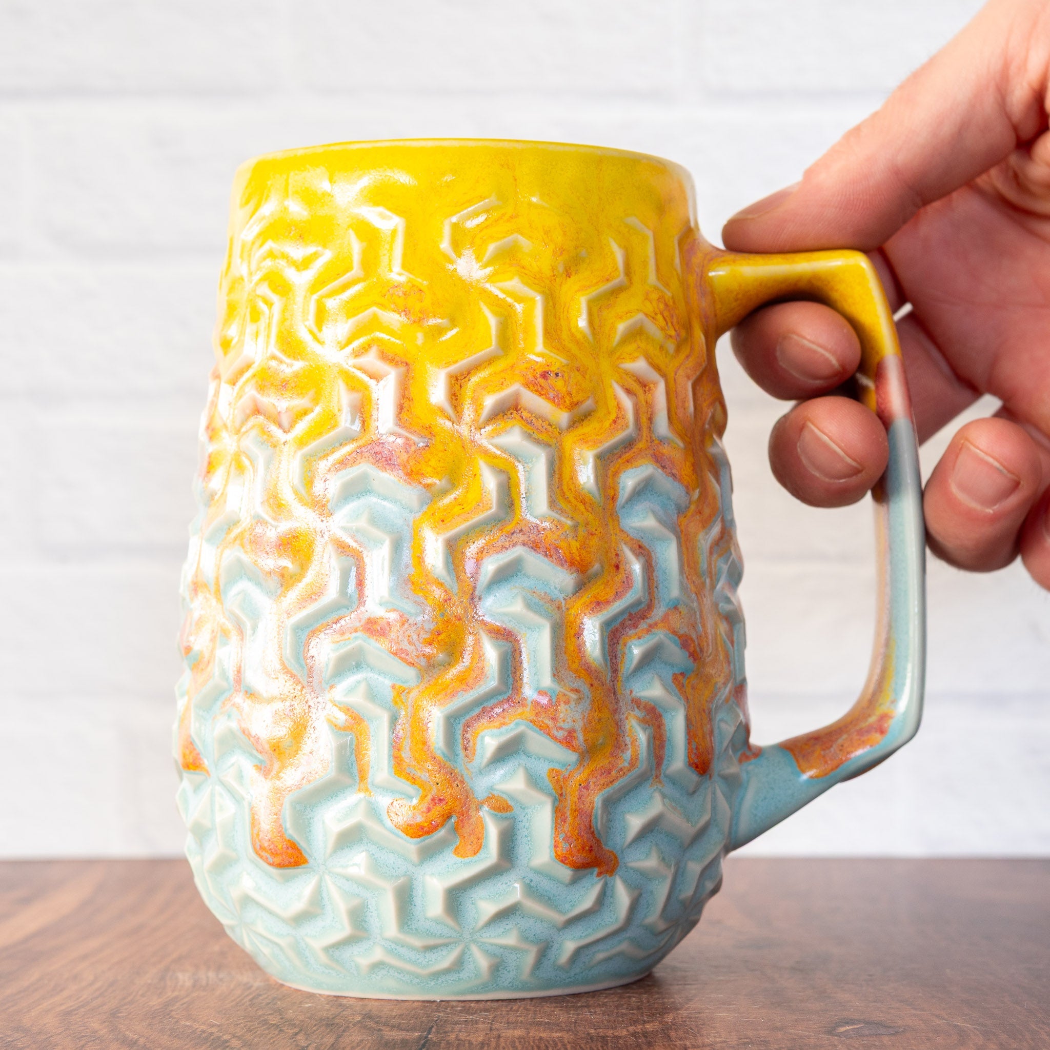Hammerly Ceramics handmade decorative statue in yellow and sky blue with flowing orange blush , interlocking geometric weave textured porcelain