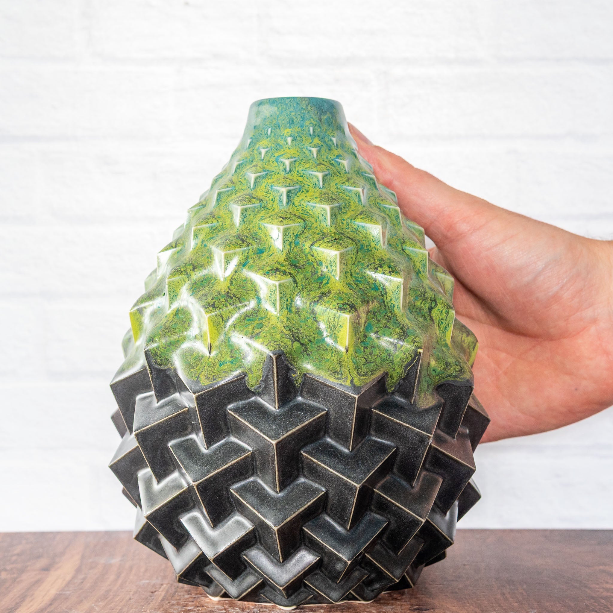 Hammerly Ceramics handmade slip-cast Stacked Cubes Vase in light green and teal flowing over charcol black, geometric textured porcelain