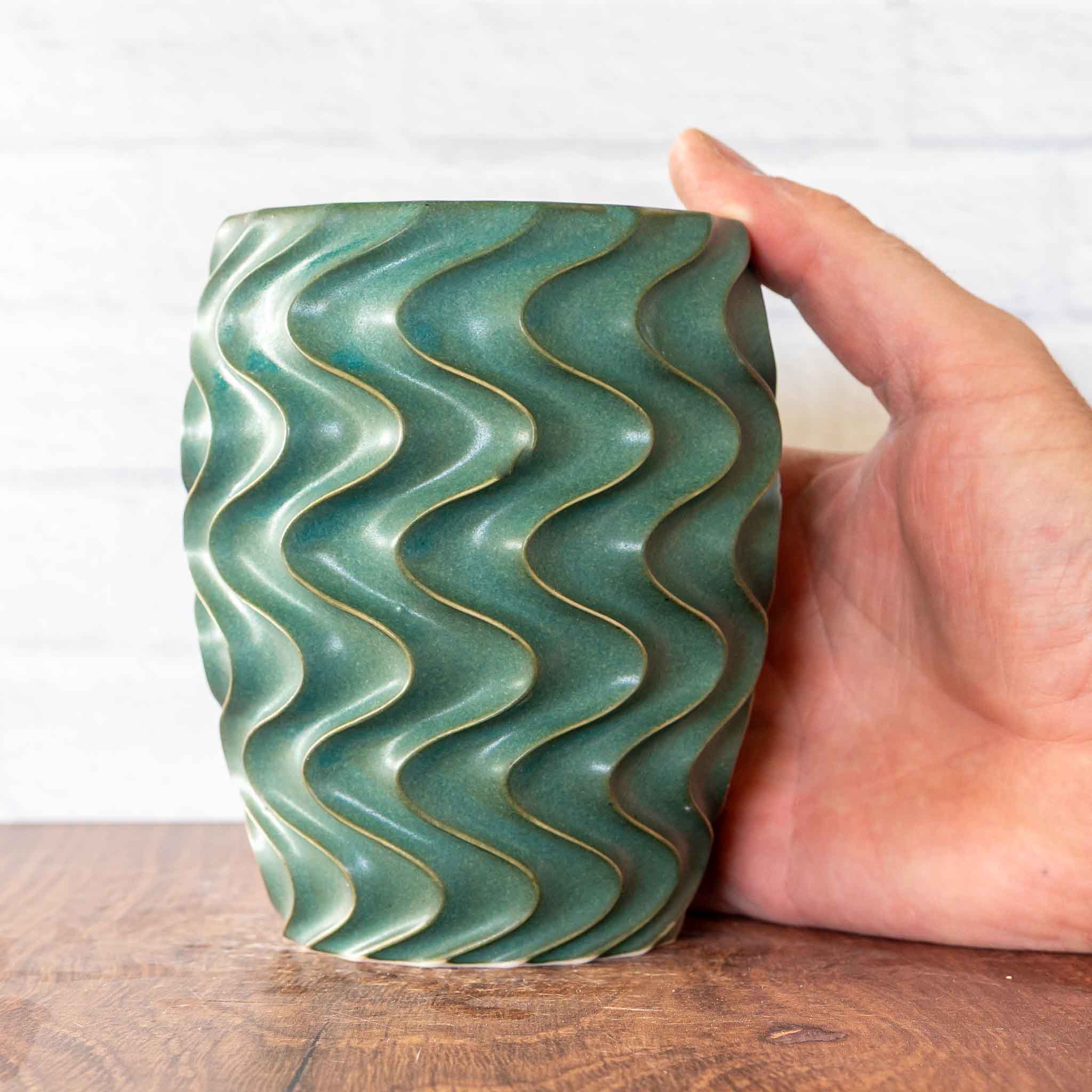 Hammerly Ceramics handmade slip-cast cup in smooth, matte jade green, deep wavy textured porcelain 