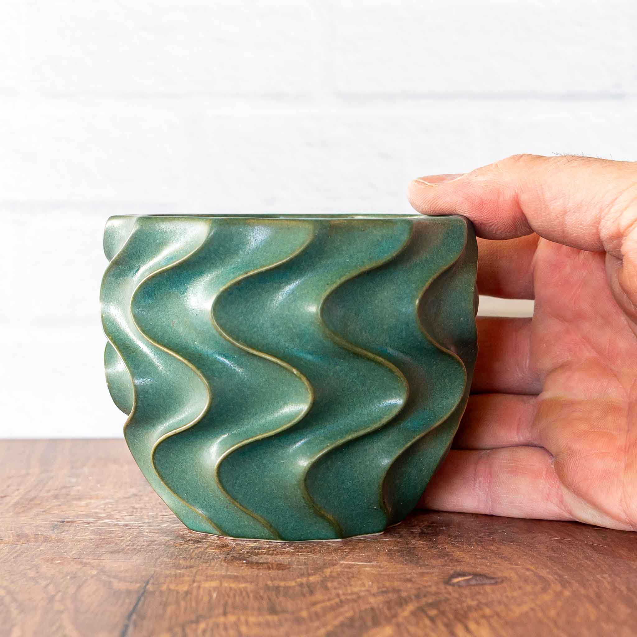 Hammerly Ceramics handmade slip-cast cup in smooth, matte jade green, deep wavy textured porcelain 