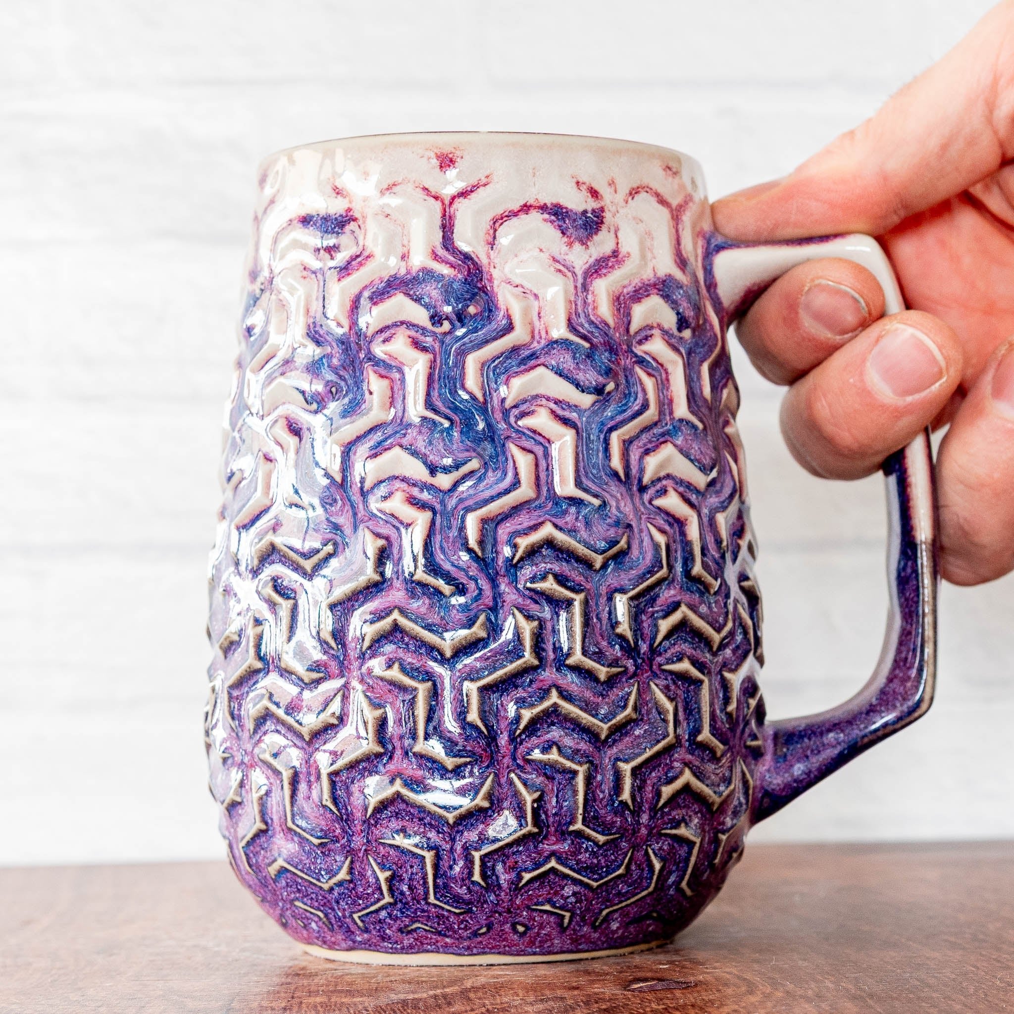 Hammerly Ceramics handmade decorative statue in white and deep navy glaze with purple drip transition , interlocking geometric weave textured porcelain