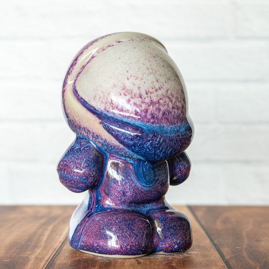 Hammerly Ceramics handmade decorative statue in white and deep navy glaze with purple drip transition, rounded astronaut form