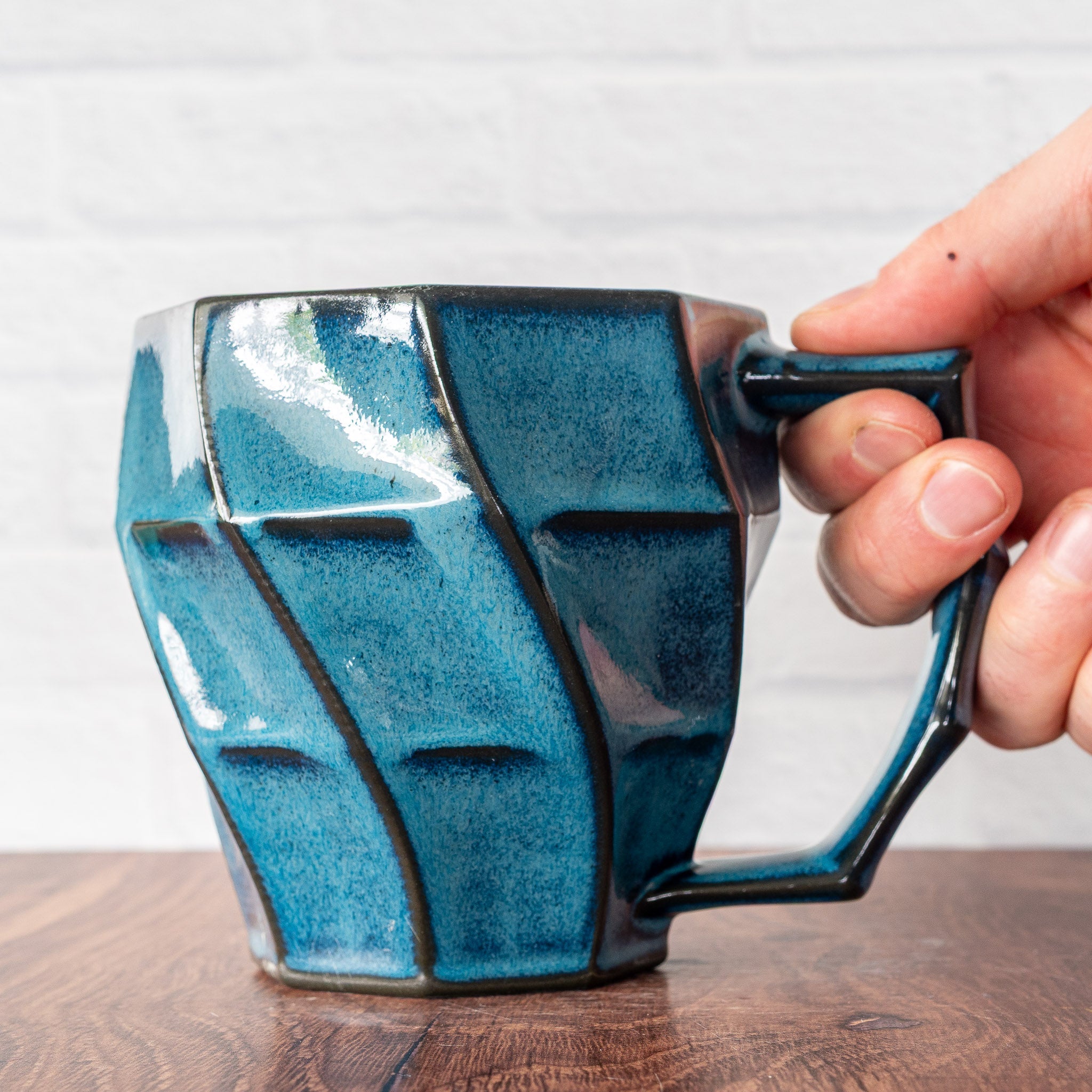 Hammerly Ceramics handmade slip-cast Classic Mug inocean blue glaze with dark charcoal edges, faceted porcelain with angular handle