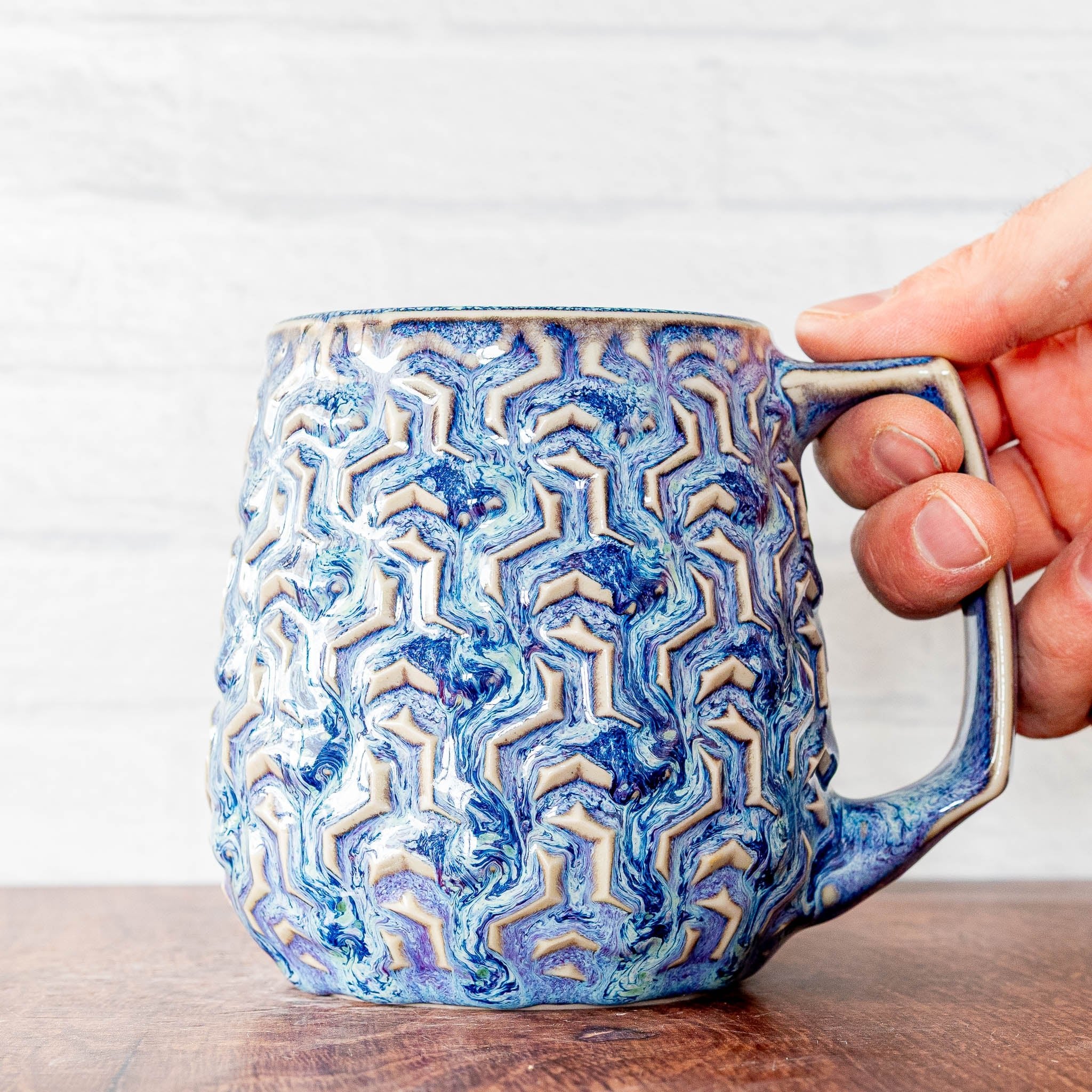 Hammerly Ceramics handmade decorative statue in swirls of various shades of blue, interlocking geometric weave textured porcelain
