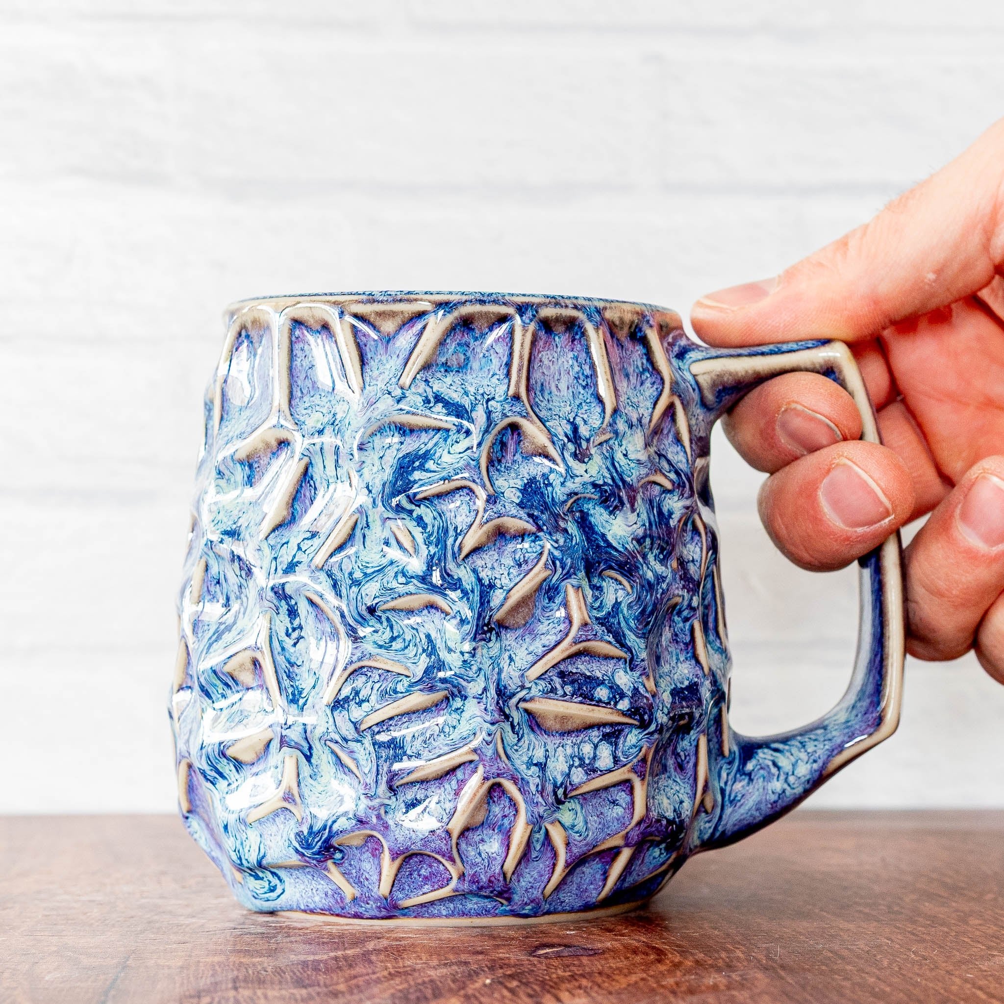Hammerly Ceramics handmade slip-cast mug in swirls of various shades of blue, geometric organic cell-like textured porcelain