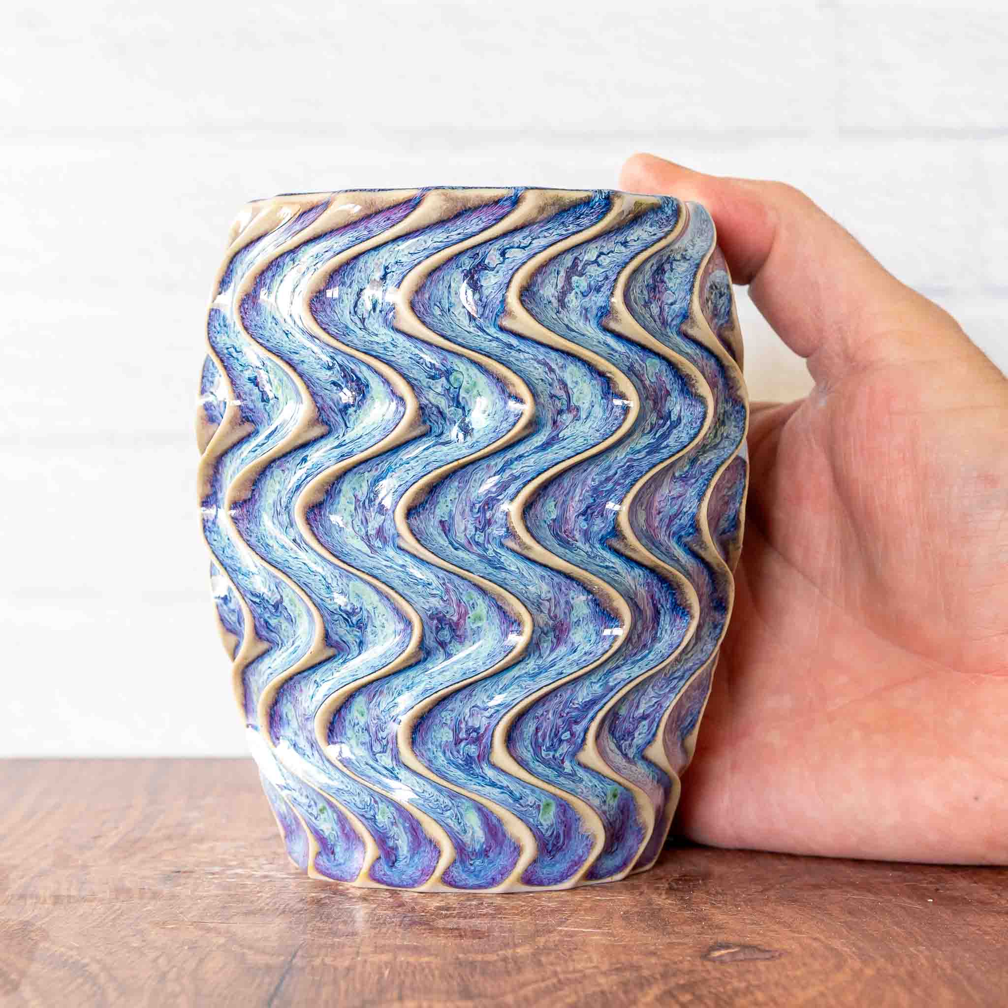 Hammerly Ceramics handmade slip-cast cup in swirls of various shades of blue, deep wavy textured porcelain 