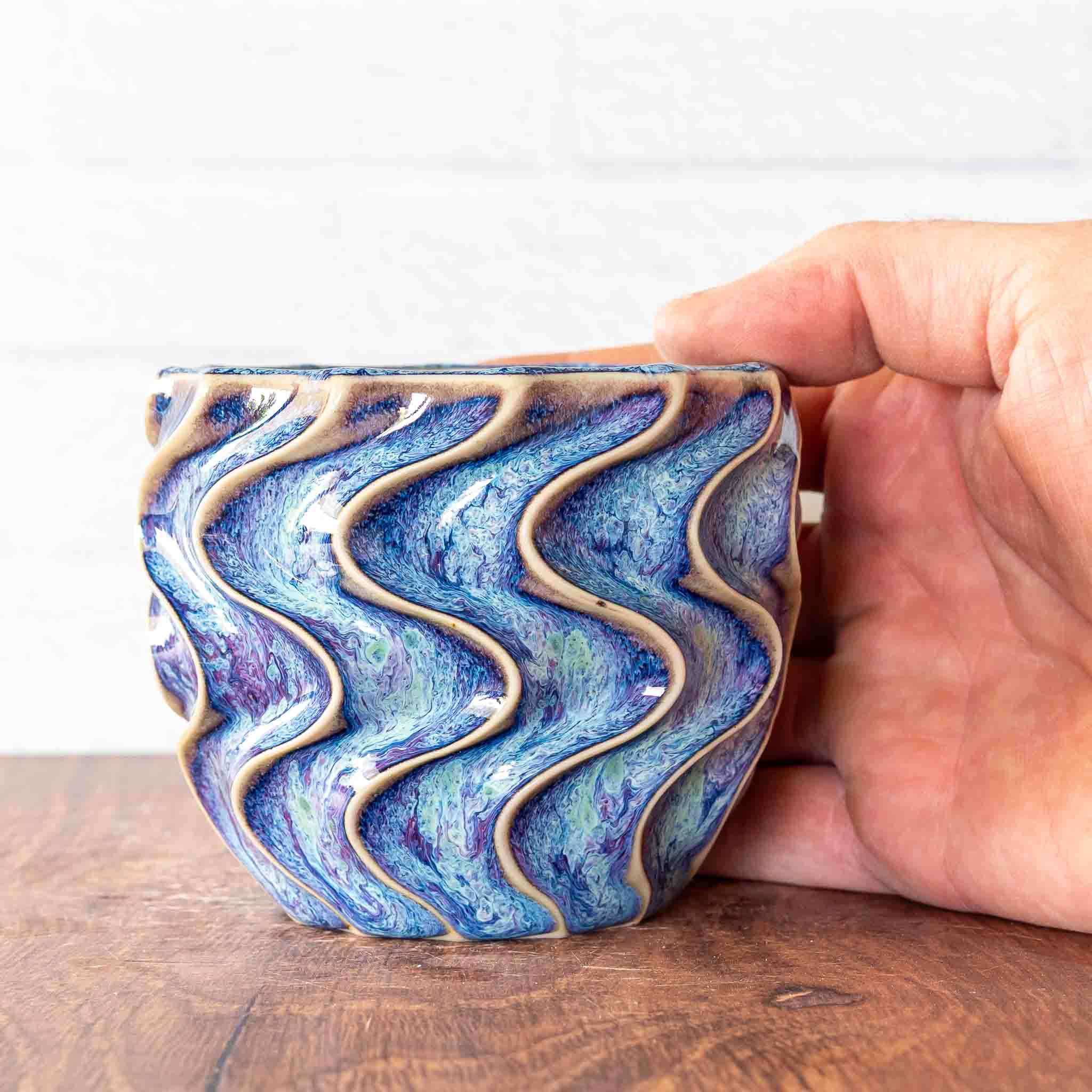 Hammerly Ceramics handmade slip-cast cup in swirls of various shades of blue, deep wavy textured porcelain 