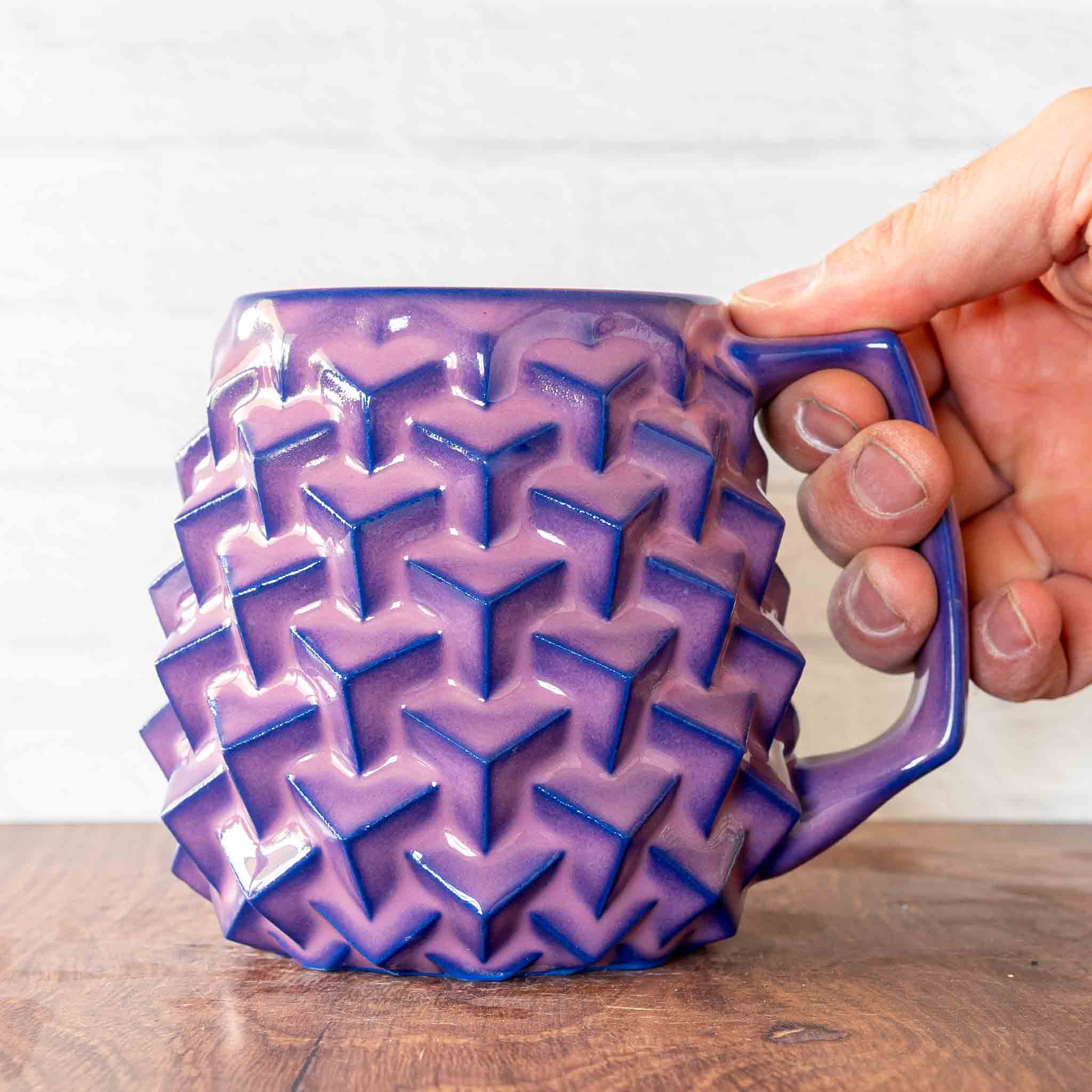 Hammerly Ceramics handmade slip-cast mug in violet over dark blue purple edges, geometric cubes textured porcelain
