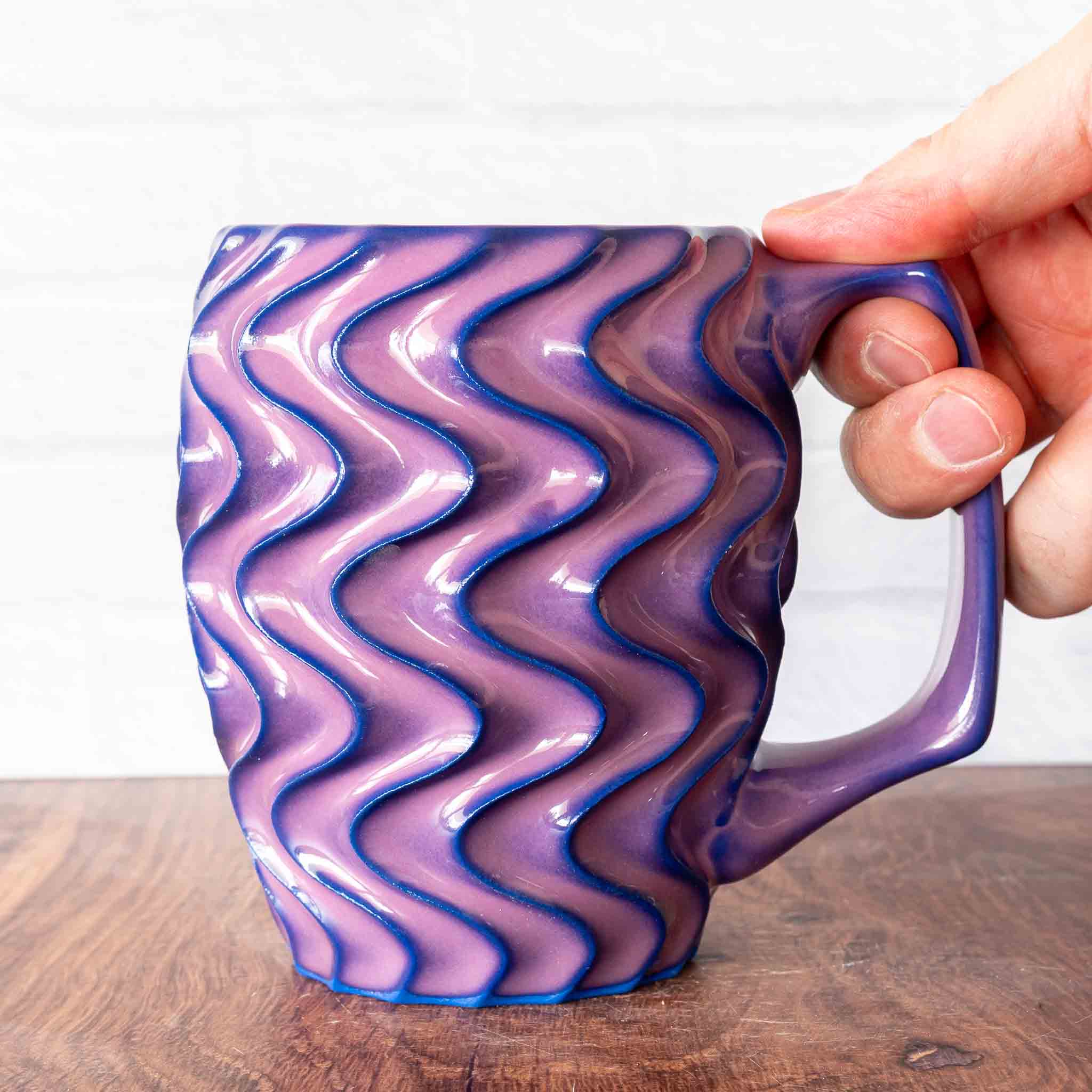 Hammerly Ceramics handmade slip-cast mug in violet over dark blue purple edges, deep wavy textured porcelain with angular handle